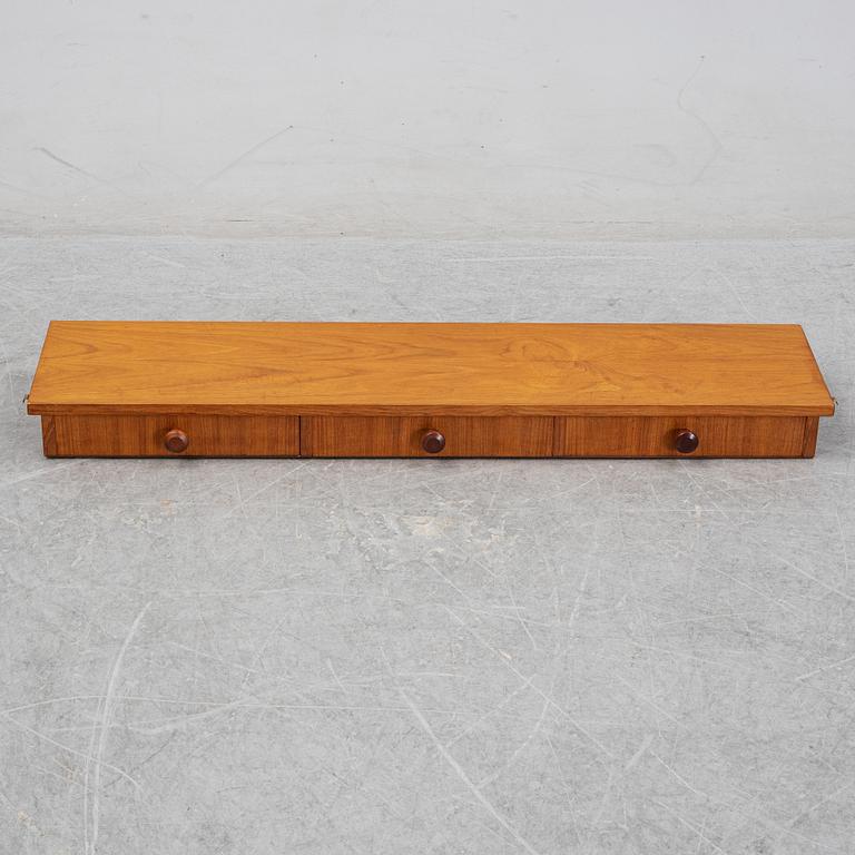 Nils Strinning, A 1950's-60's teak veneered shelf with brackets.