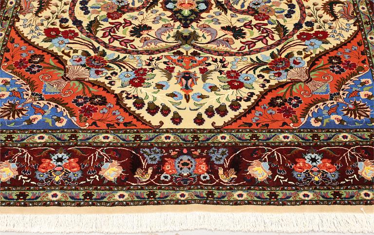 A part silk Tabriz rug, so-called 50 Raj, approx. 242 x 178 cm.