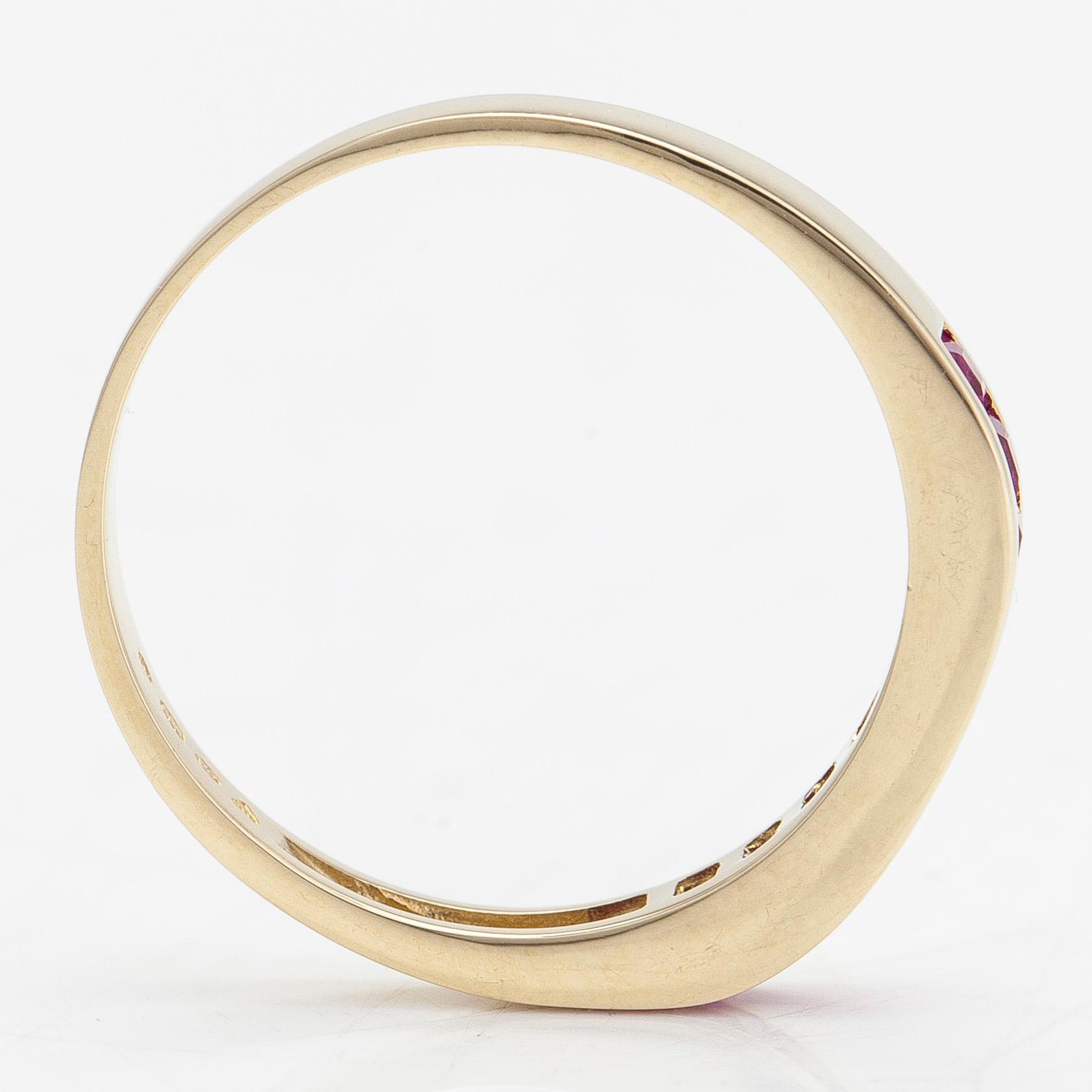 A 14K half eternity gold ring, with rubies.