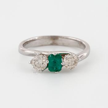A emerald and brilliant cut diamond ring.