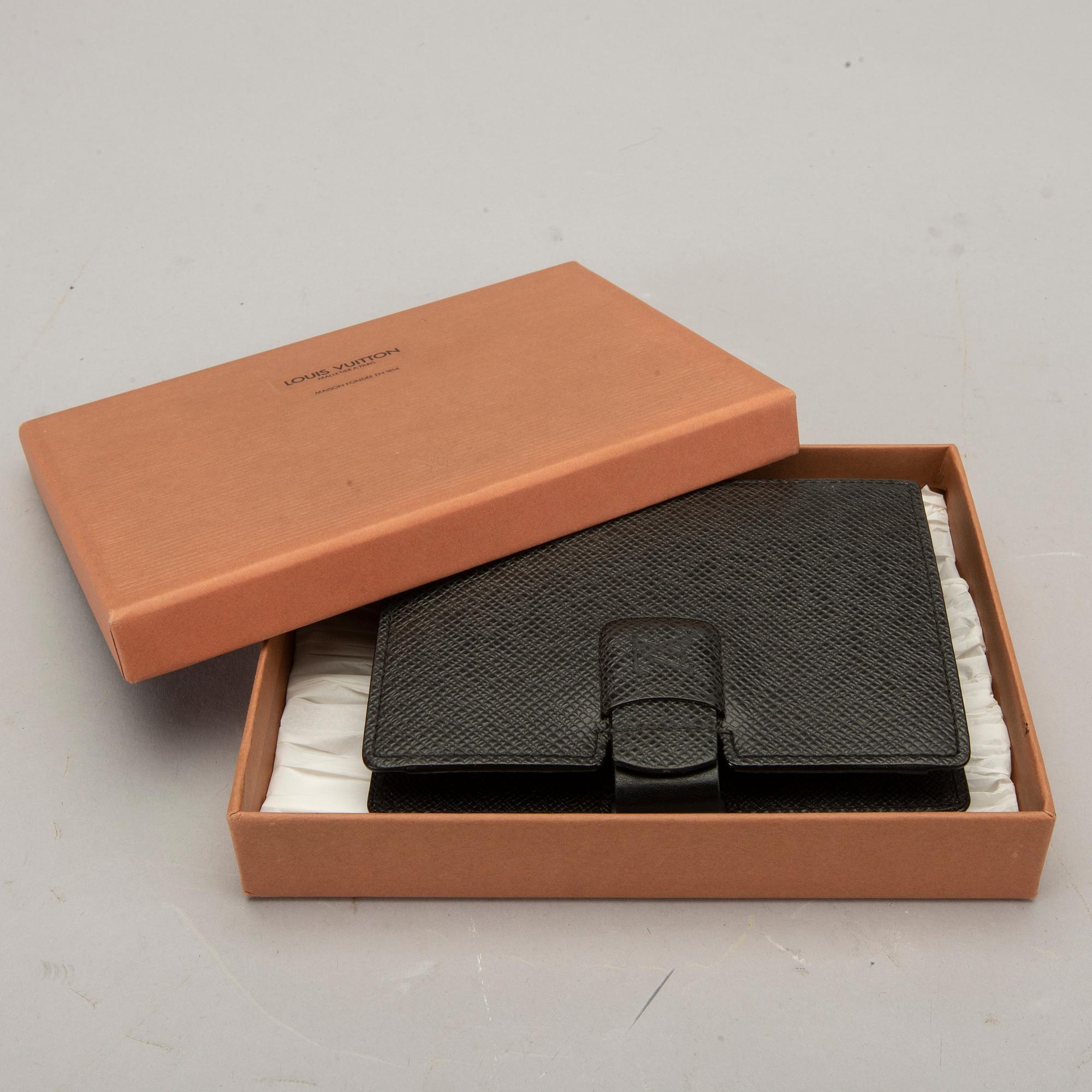 A Louis Vuitton palm pilot leather cover.