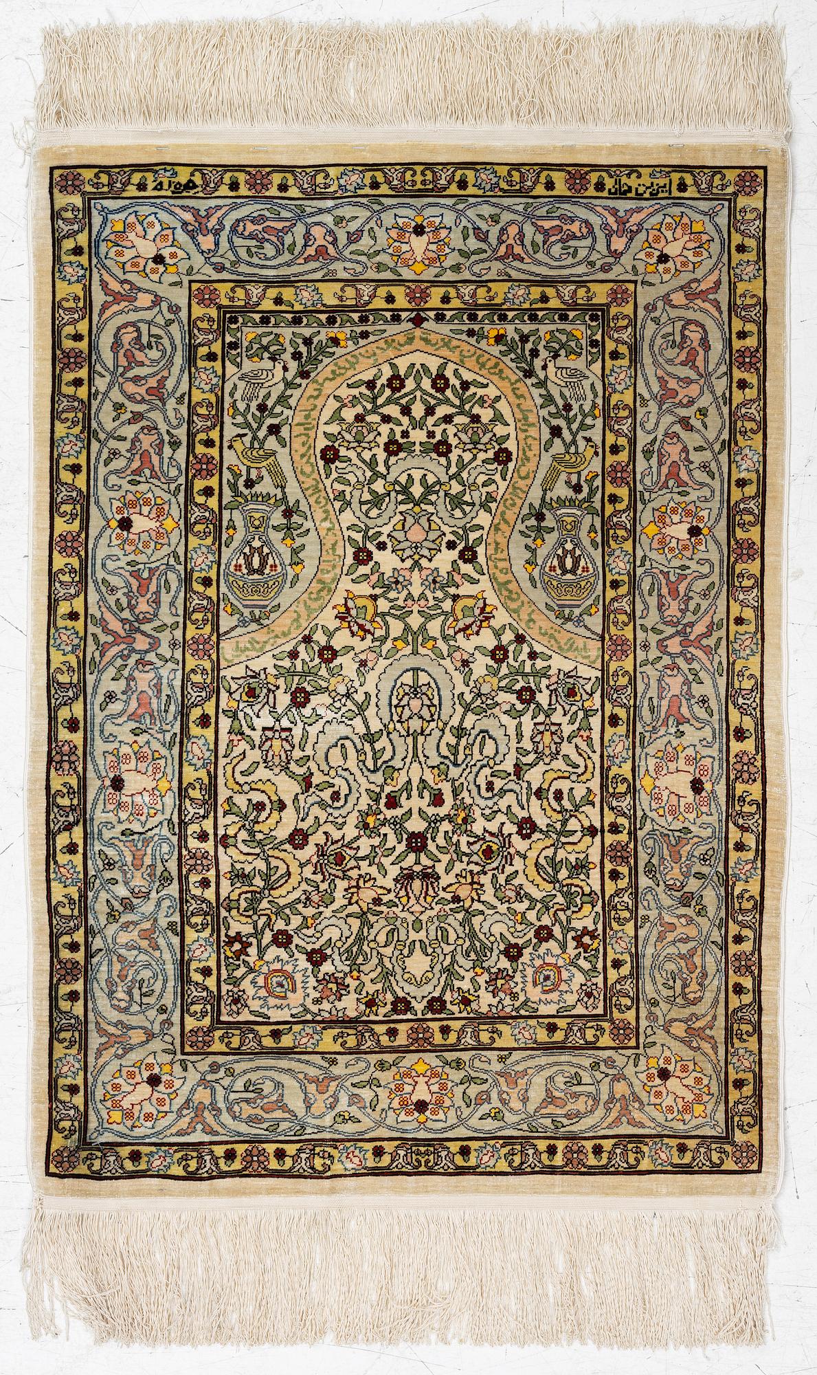 A silk Hereke rug, Turkey, approx. 82 x 58 cm.