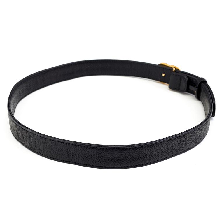 A black leather belt by Chanel.