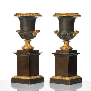 A pair of French Louis Philippe gilt and patinated bronze urns, first part 19th century.