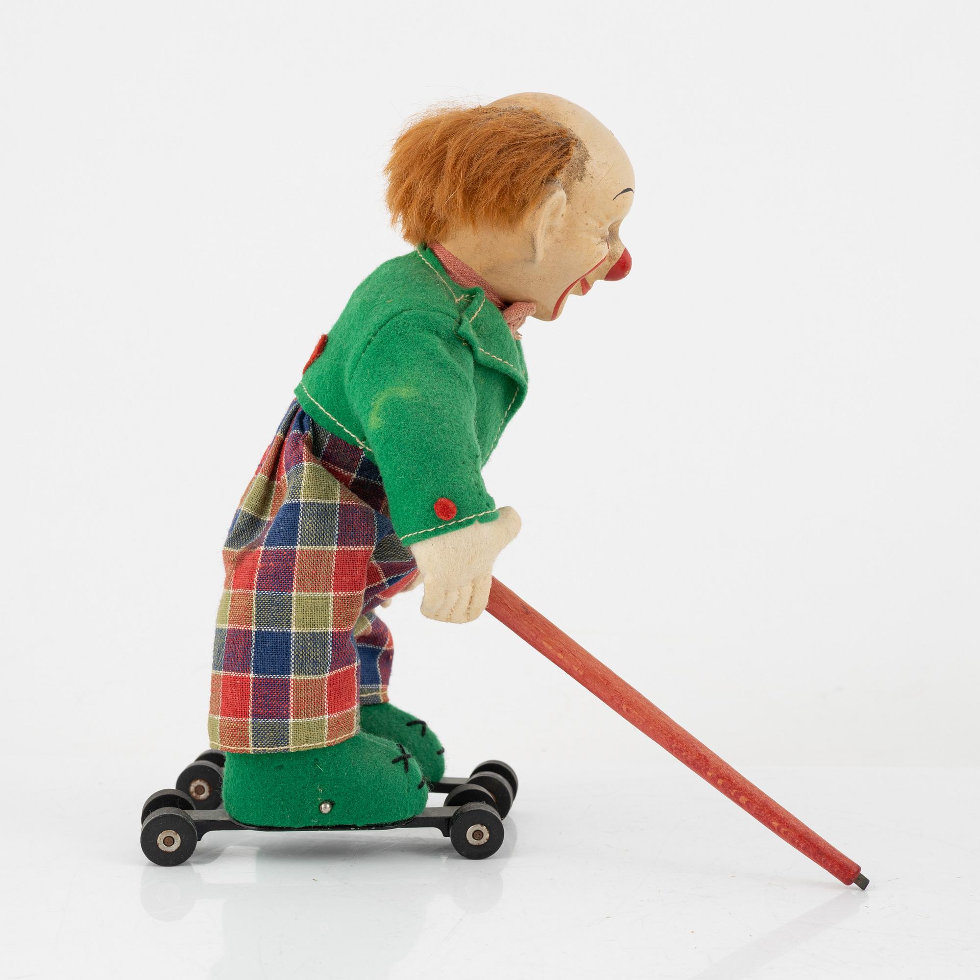 A set of five toys, including 'Rolly' clown from Schuco, 20th century.
