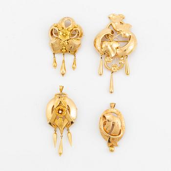 Four 18K gold brooches.