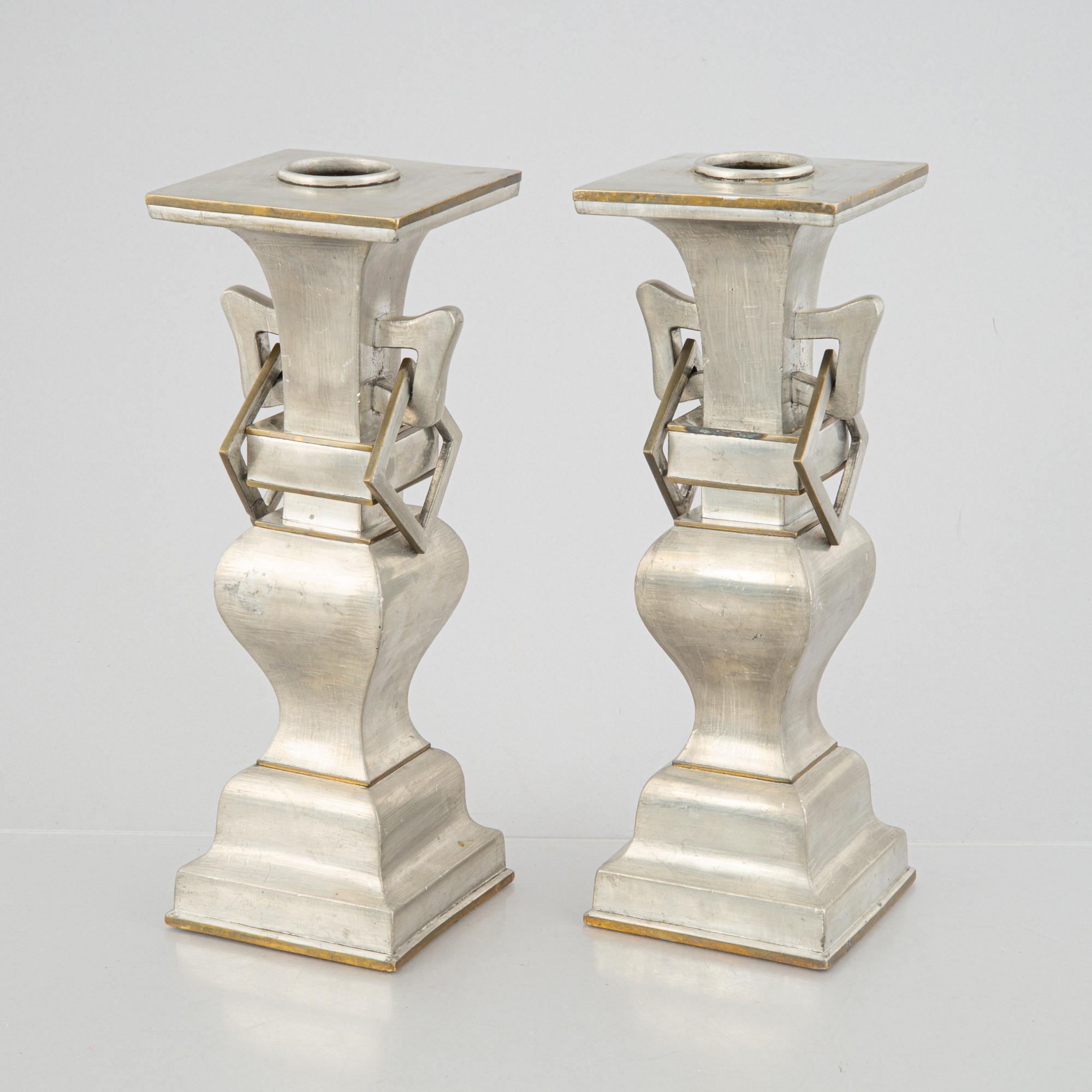 A pair of Chinese pewter and brass altar pieces, late Qing dynasty.