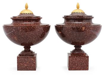 A pair of late Gustavian early 19th century porphyry urns with covers.