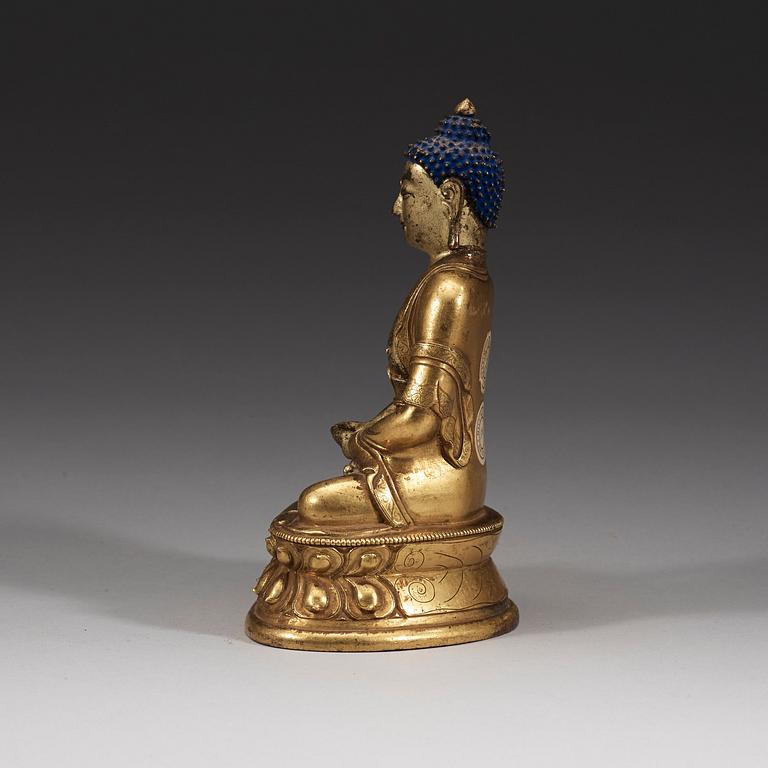 A seated Sino-Tibetan part gilt bronze figure of Amithaba Buddha, 18th Century.