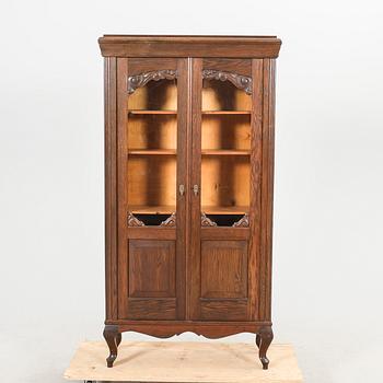 A 1920s oak display cabinet.