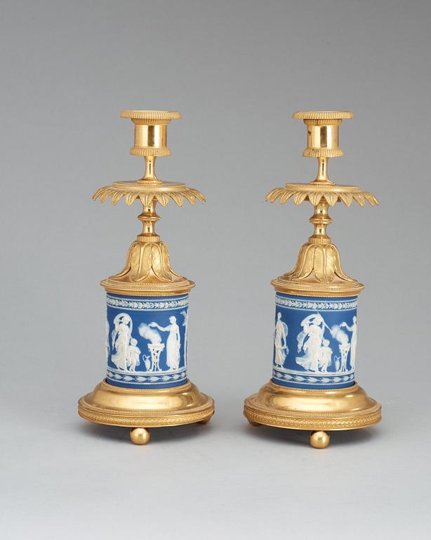 A pair of Victorian Wedgewood and gilt bronze candlesticks.