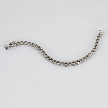 A TENNIS BRACELET set with round brilliant-cut diamonds.