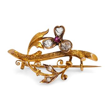 A 14K gold brooch set with rose-cut diamonds and a ruby.