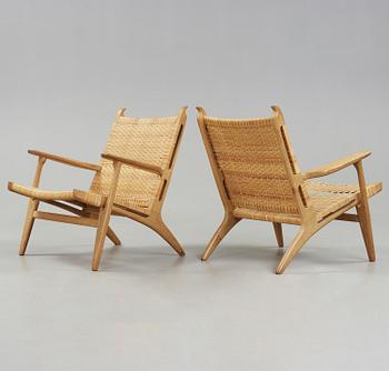 A pair of Hans J Wegner oak and rattan easy chairs 'CH-27', Carl Hansen & Son, Denmark.