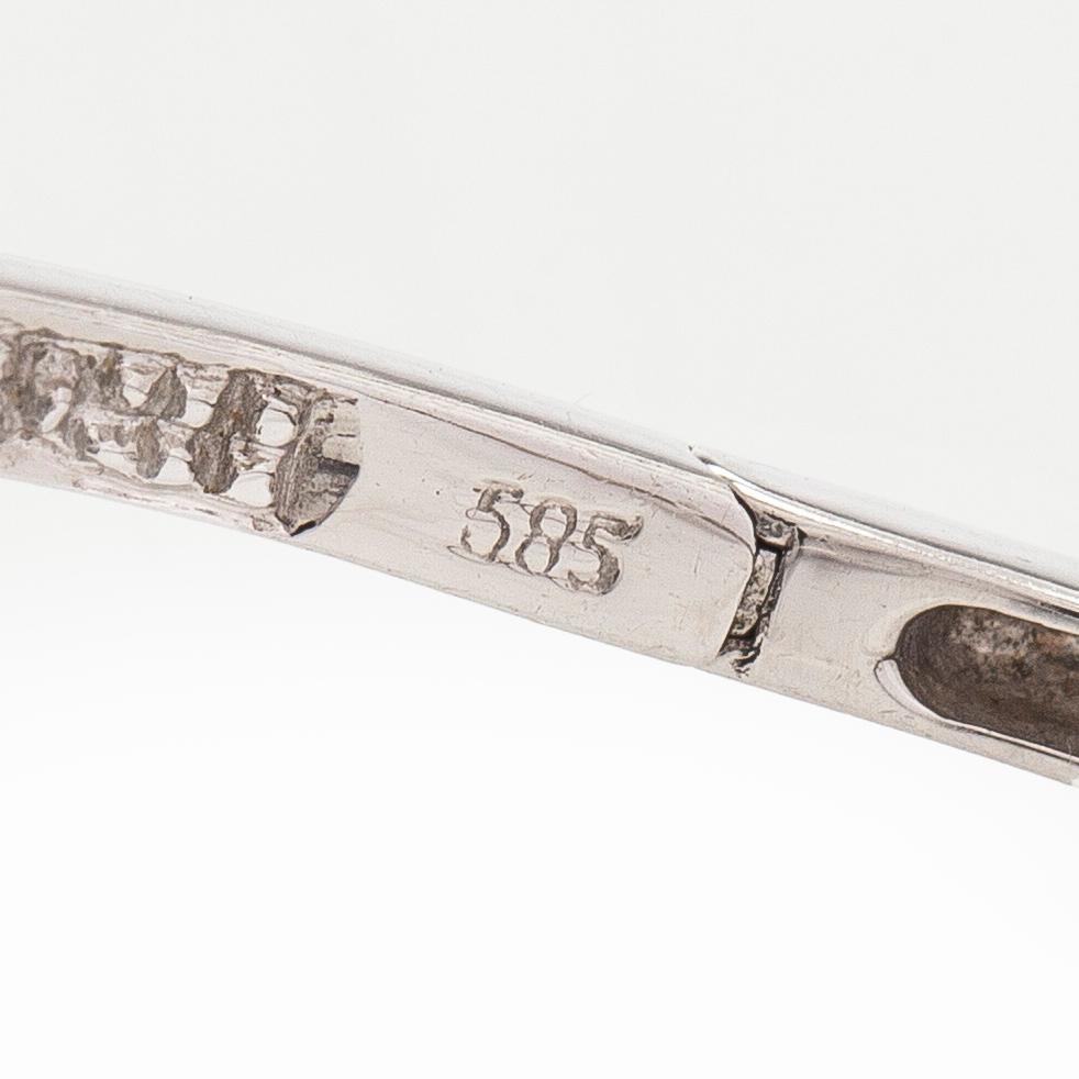 A pair of 14K white gold  hoop earrings with diamonds.