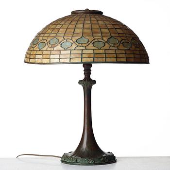 TIFFANY STUDIOS, an Art Nouveau "Vine Border" shade on a "Double Scroll" bronze base table lamp, New York 1902-1918.