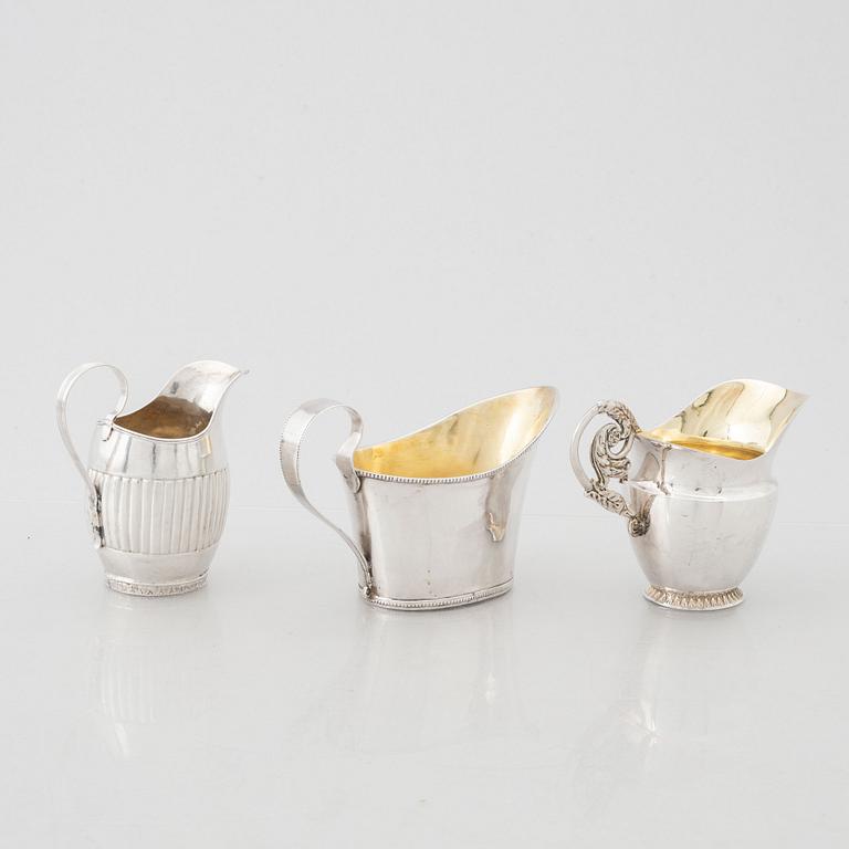 Three early 19th century Empire silver creamers,.