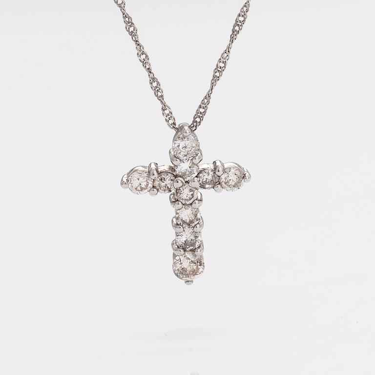 A platinum necklace with a cross pendant set with brilliant-cut diamonds 0.50 ct acording to engraving.