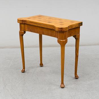 An end of the 19th Century Queen Anne-style card table.