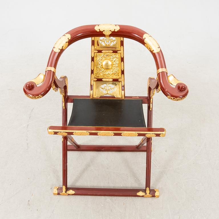 A laqcuered wooden chair from China 21st century.