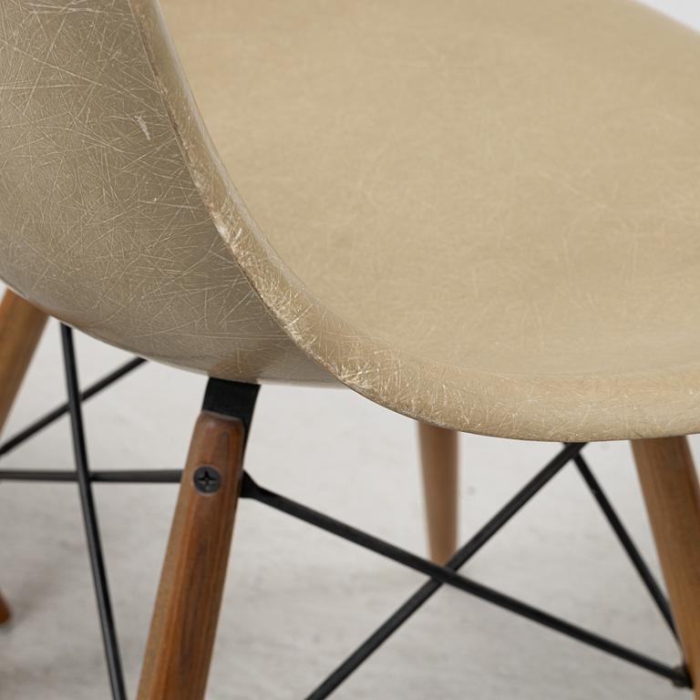 A set of four 'Plastic Chairs DSW' by Charles & Ray Eames for Herman Miller with new legs from Vitra.