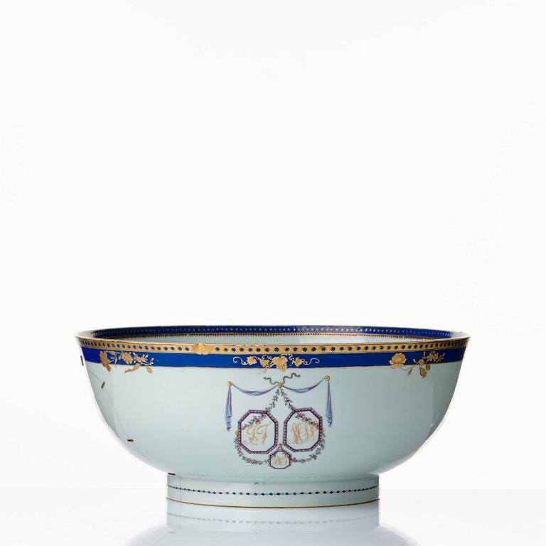 A pair of large famille rose punch bowls with stands, Qing dynasty, 18th Century.