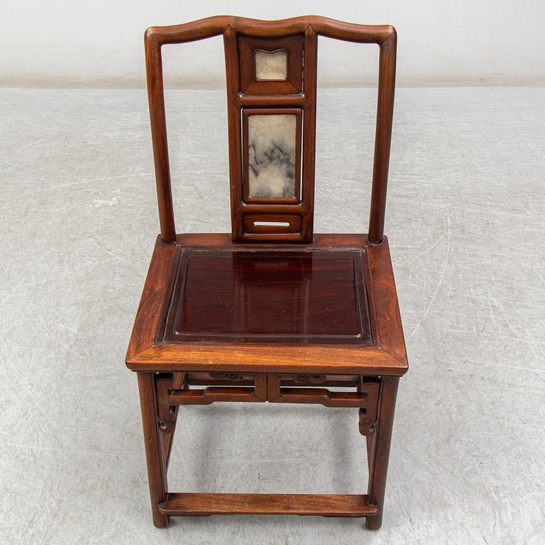A pair of Chinese hardwood armchairs, early 20th century.