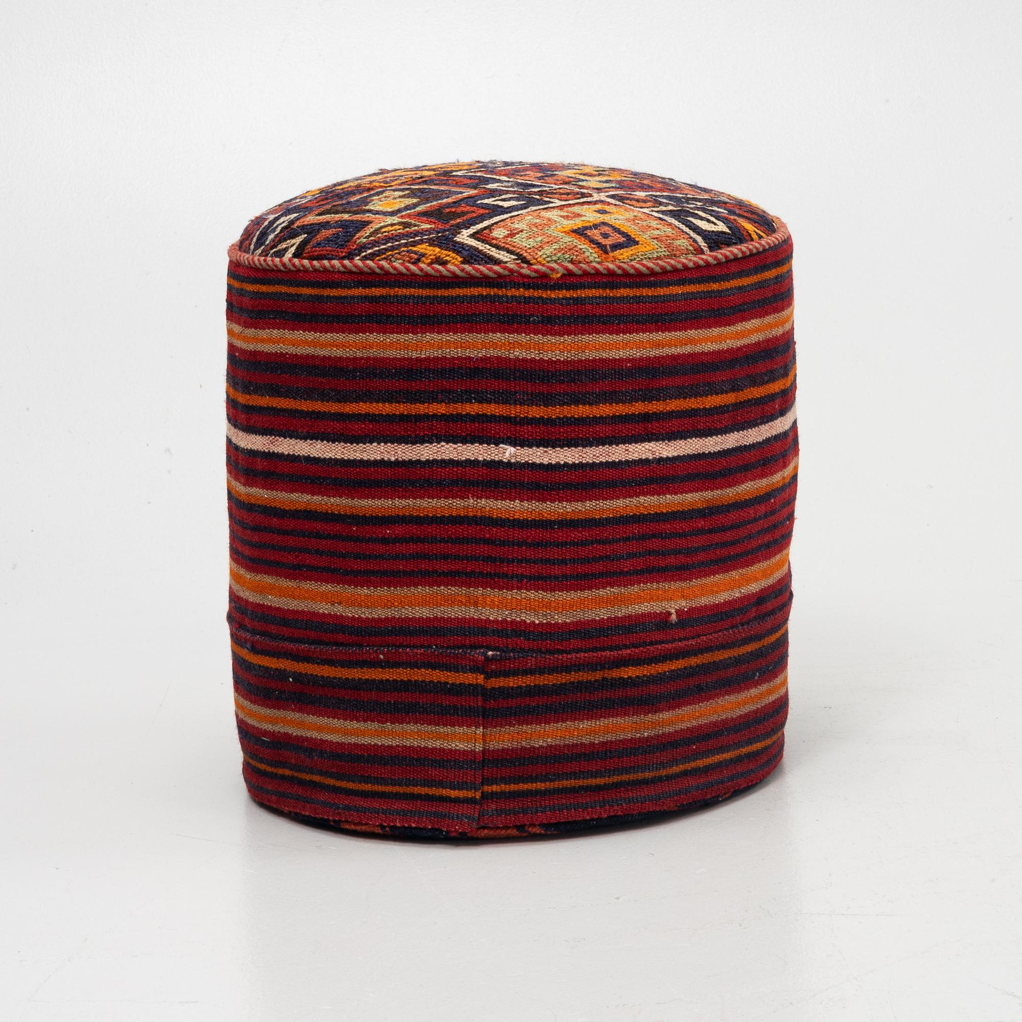 A Kelim covered stool.