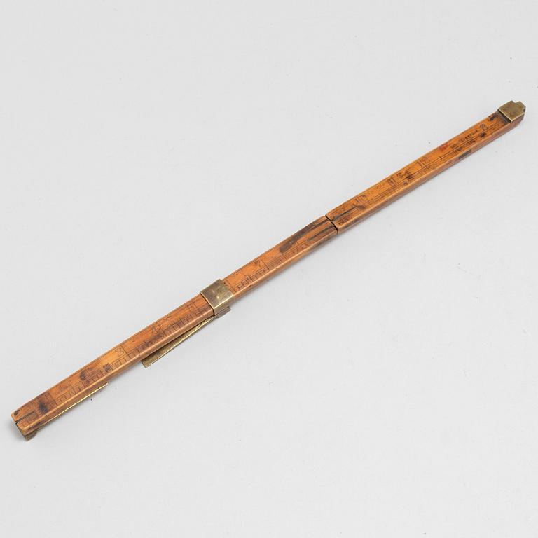 A 19th century wooden measuring stick.