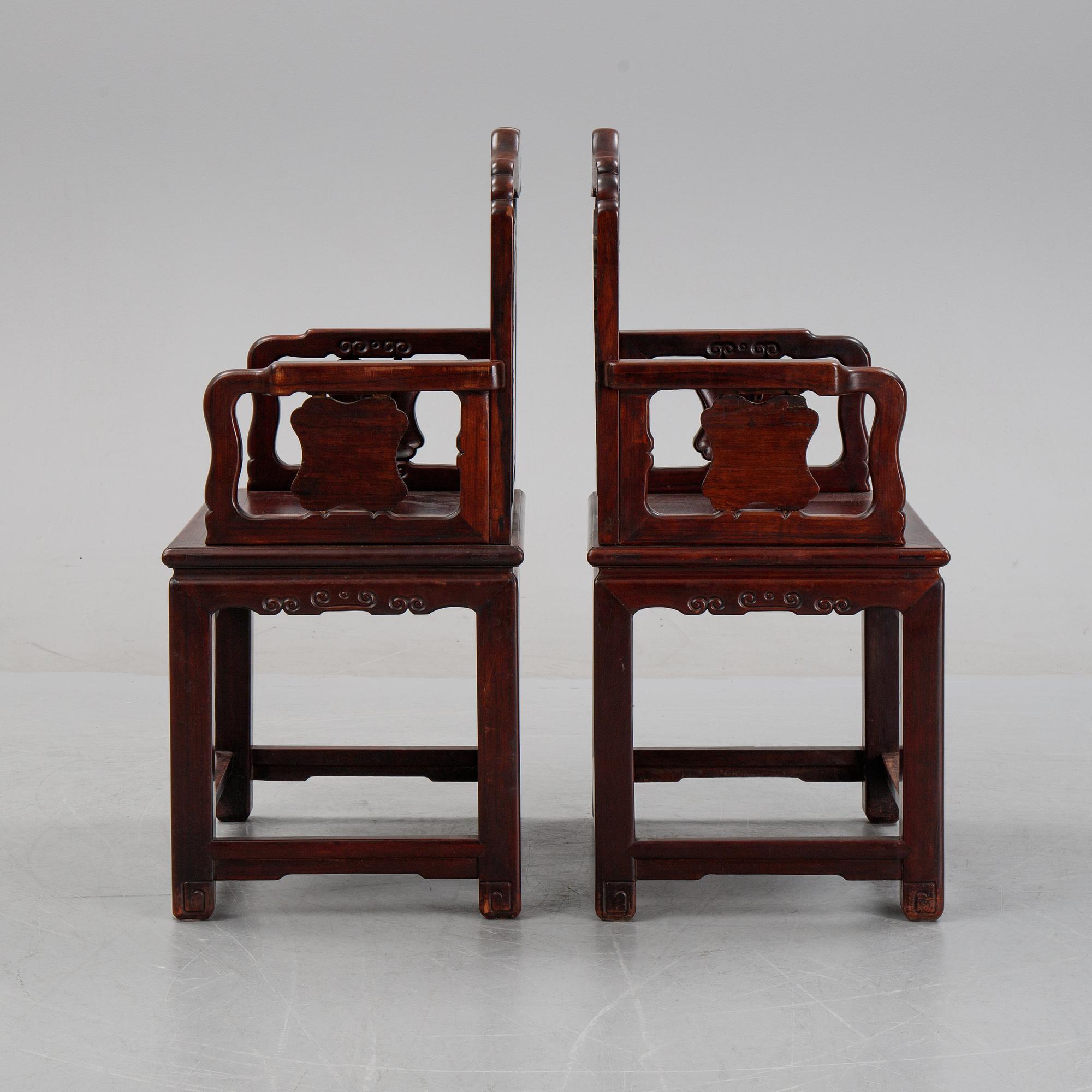 A pair of Chinese hardwood armchairs, presumably late Qing dynasty 19th century.