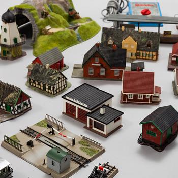 A model train set with locomotives, wagons, rail H0, Danish village houses, tunnel, mountain and more.