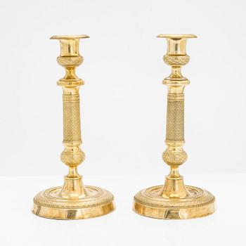 A pair of early 19th century French gilded Empire candlesticks.
