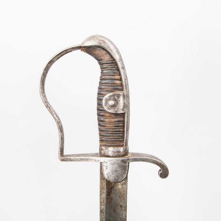 A German sabre with scabbard and a cutlass.