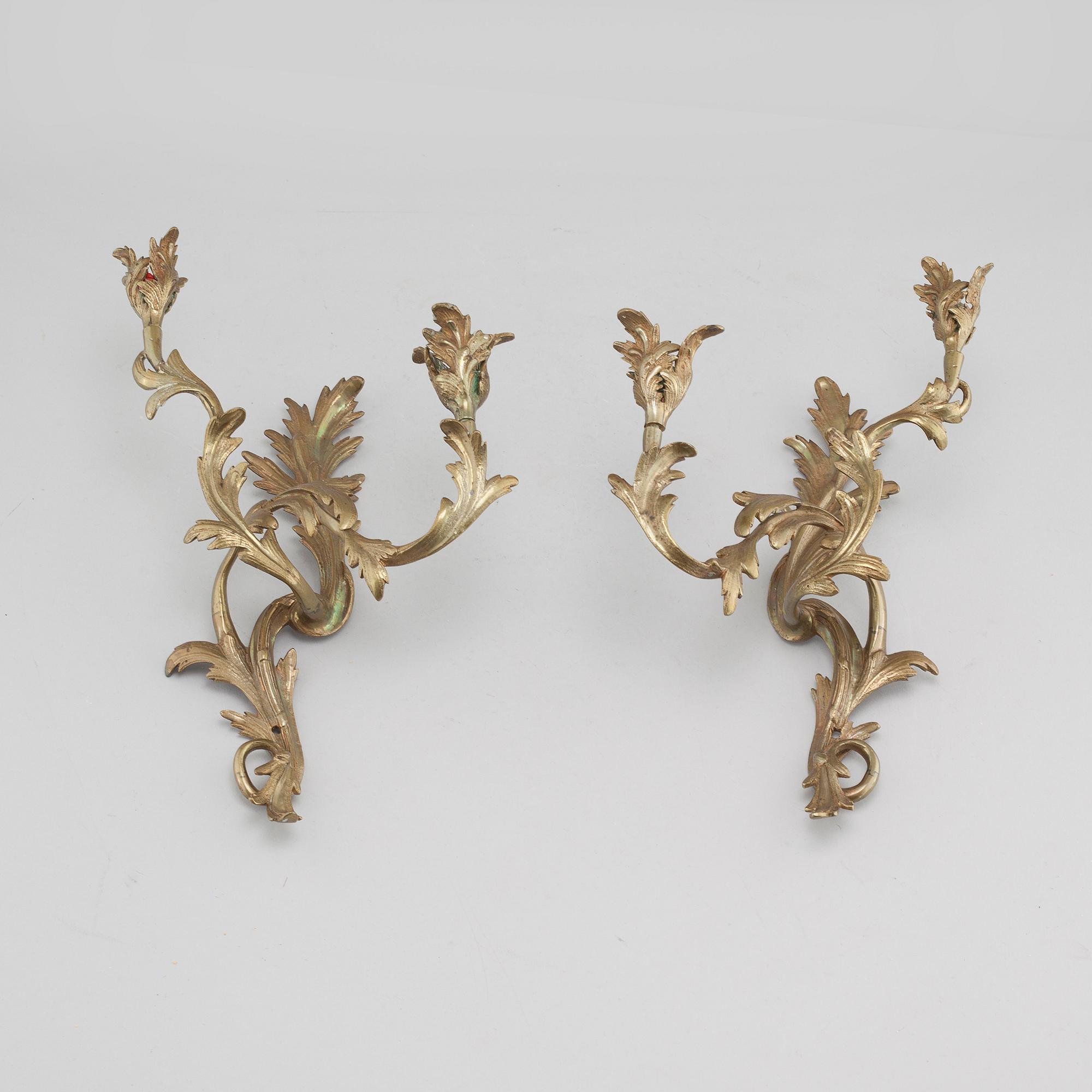 A pair of Louis XV-style brass wall sconces first half of the 20th century.