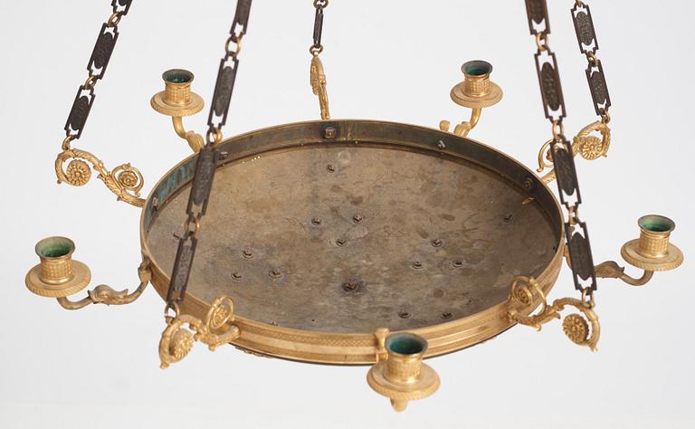 An Empire.style five-branch patinated and gilt bronze chandelier, later part of the 19th century.