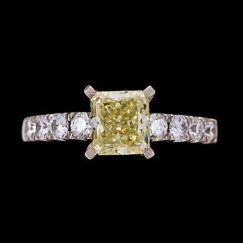 A fancy yellow radiant cut diamond ring, 1.57 cts, and brilliant cut diamonds, tot. app. 0.30 cts.