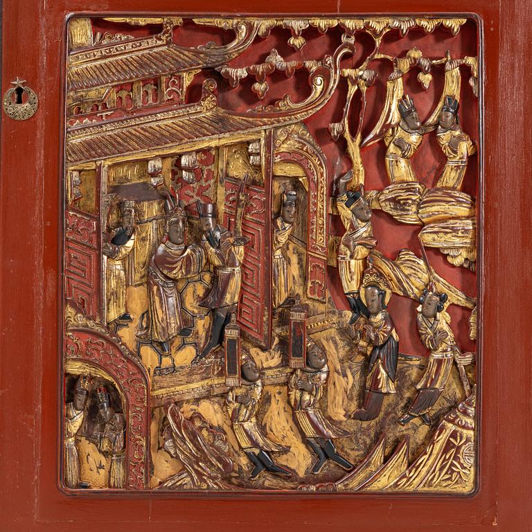 A Chinese cabinet, early 20th Century, with 19th Century carved panels.