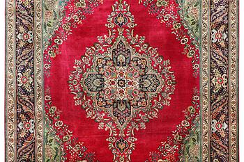 A Tabriz carpet, c. 330 x 250 cm.