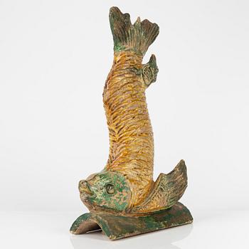 A green and yellow glazed roof tile figure of a fish, Ming dynasty (1368-1644).