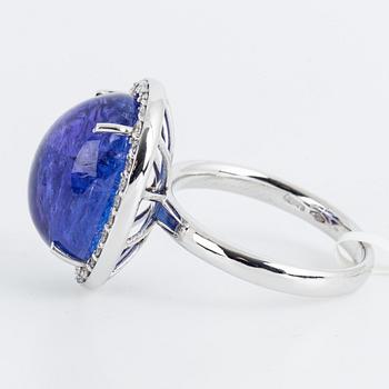 Cabochon-cut tanzanite and brilliant-cut diamond cocktail ring.