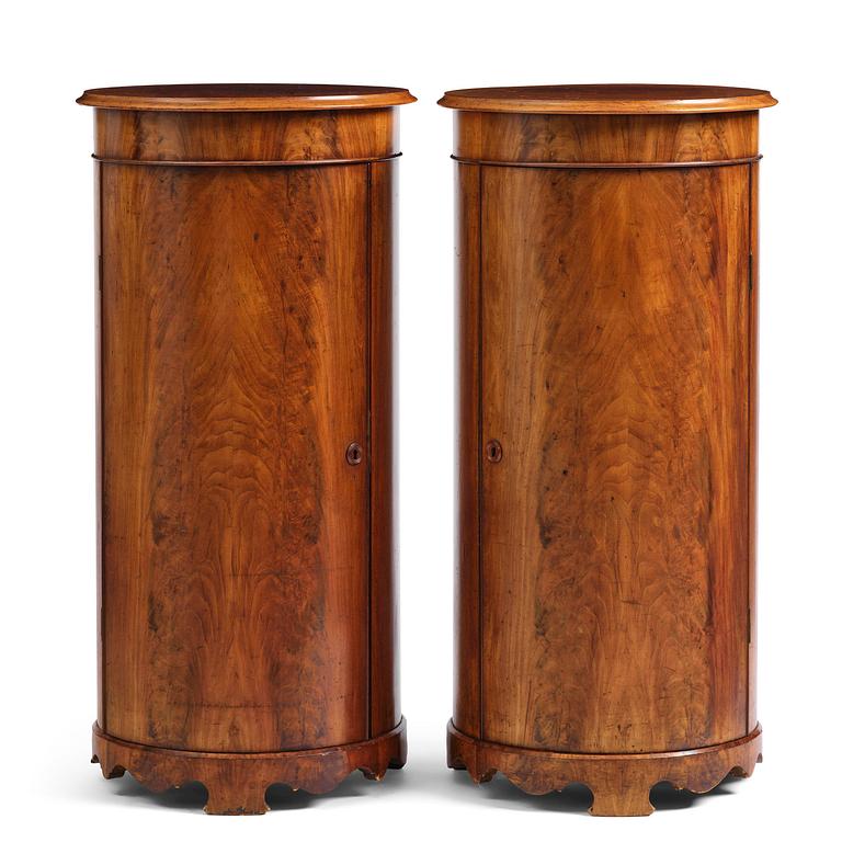 A pair of late Empire mahogany column cabinets, mid 19th Century.