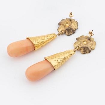 A pair of brass tone metal and stone earrings, Firma Svenskt Tenn.