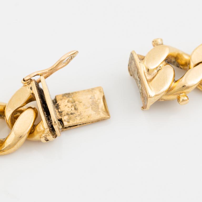 18K gold curb link bracelet.