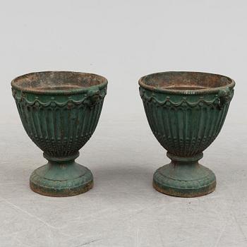 A pair of early 20th century iron garden urns.