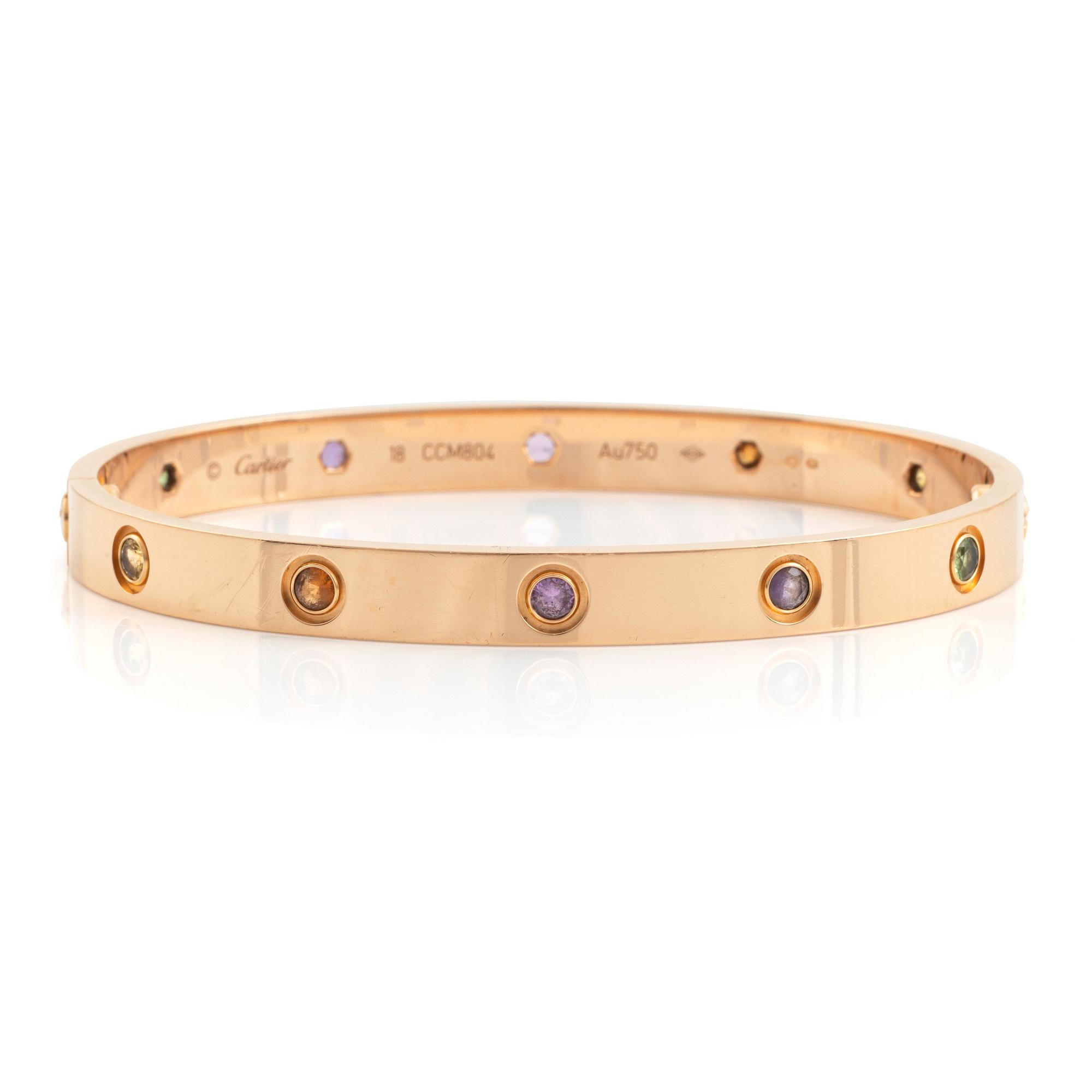 A Cartier "Love" bracelet in 18K rose gold set with colored stones.