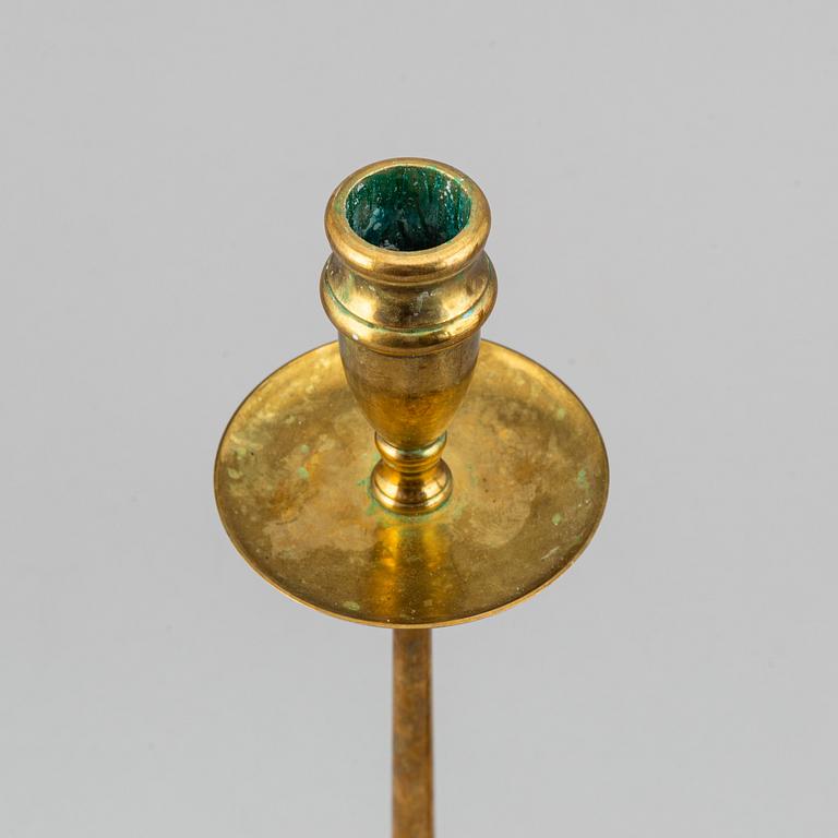 A pair of model 2539 brass candlesticks, for Firma Svenskt Tenn, designed ca 1949-50.
