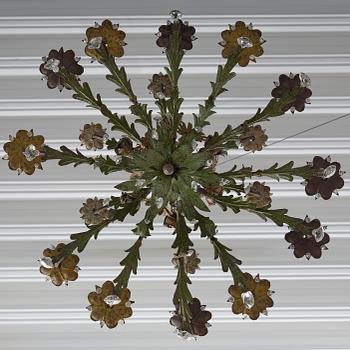 A North-Italian iron and tole-peinte eighteen-branch chandelier, 19th century.