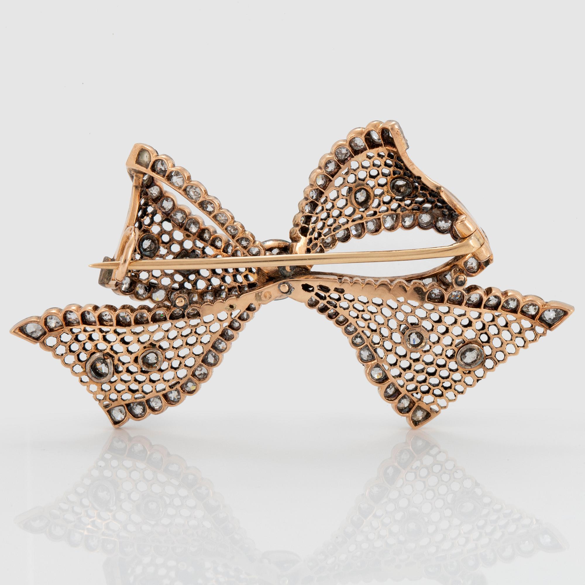 A 14K gold brooch set with old-cut diamonds.