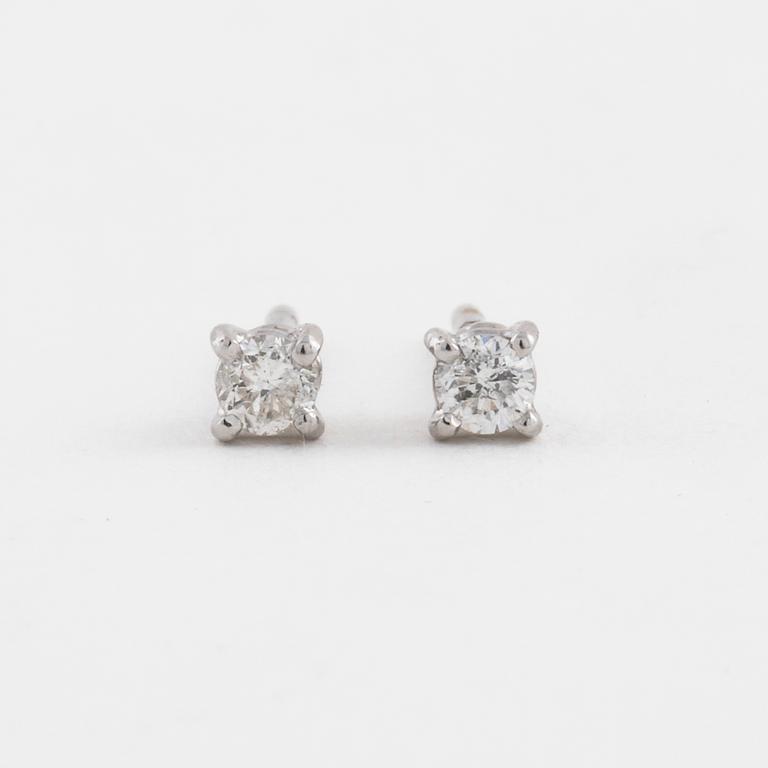 A pair of brilliant cut diamond earrings.