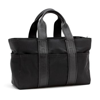 HERMÈS, a black nylon bag with leather details.